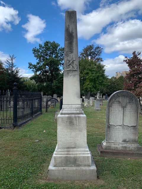 Commodore John Thomas Newton's obelisk gravestone in Presbyterian Cemetery, featuring an anchor symbolizing his naval service and steadfast hope.