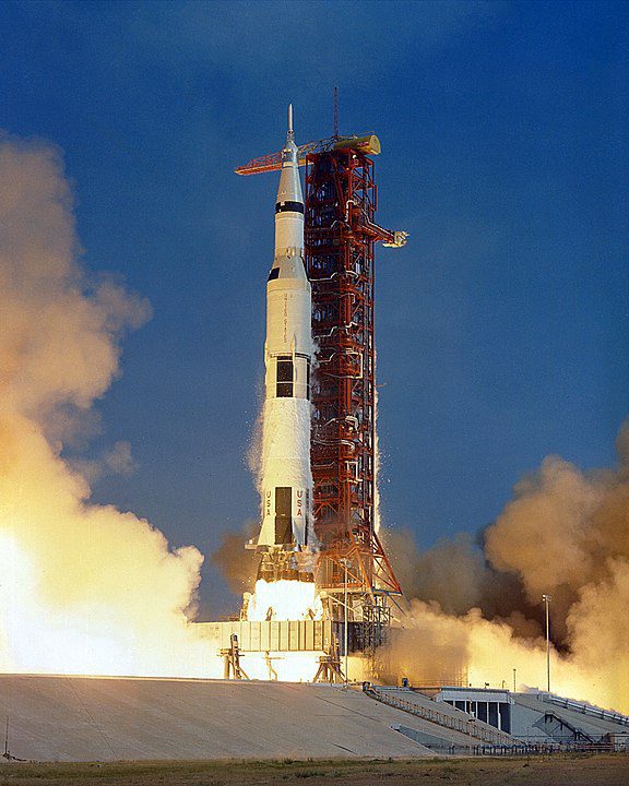 The Apollo 11 Saturn V rocket lifts off from Kennedy Space Center on July 16, 1969, carrying astronauts Neil Armstrong, Michael Collins, and Buzz Aldrin to the Moon. Designed by Wernher von Braun, the Saturn V was instrumental in the Moon landing. NASA photo.