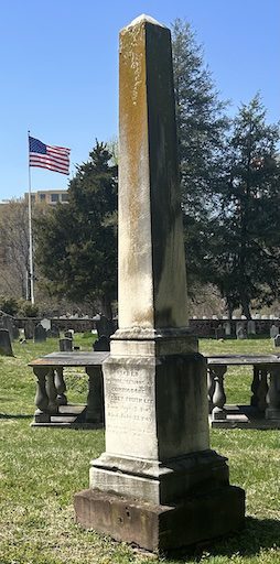 Obelisk of Sydney Smith Lee and Anna Maria Mason in the Christ Church Cemetery, Wilkes Street Complex, Alexandria, VA. The flag flying in the background is located in the Alexandria National Cemetery, the second oldest federal cemetery established in 1862 as the resting place for Union soldiers who died during the American Civil War. 