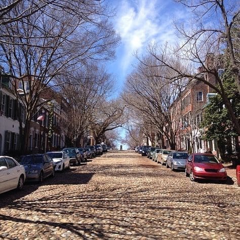 View of Captain’s Row, 100 block of Prince Street in Alexandria, showing cobblestone street and brick rowhouses rebuilt after the Great Fire of 1827