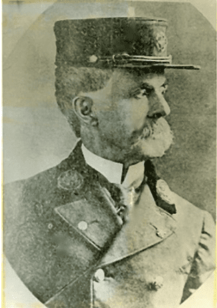 Portrait of Fire Chief George W. Petty in uniform and hat, honoring his service to the Alexandria Fire Department."