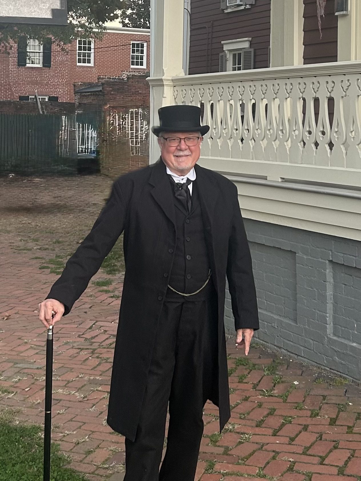 Public historian David Heiby portraying Mayor E. E. Downham outside the Lee-Fendall House Museum in Alexandria, Virginia, dressed in 19th-century formal attire with top hat and walking cane.