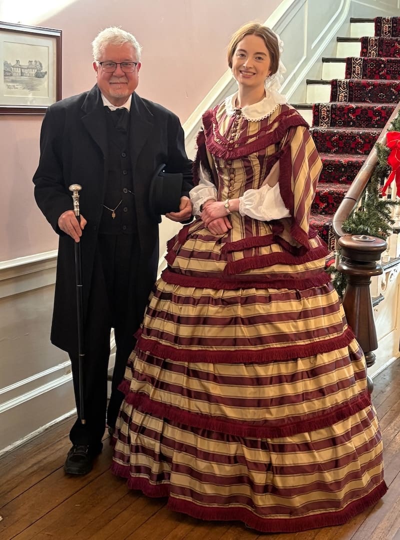Public historian David Heiby portraying Emanuel Ethelbert “E. E.” Downham alongside historic fashion specialist Emma Rowland during the Lee-Fendall House Museum Members Open House on December 20, 2026.